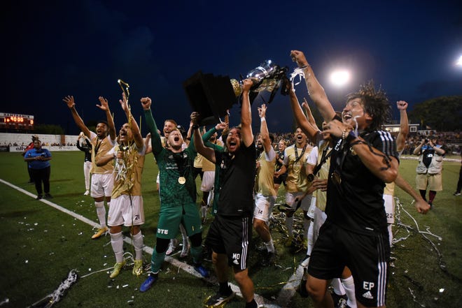 Detroit City FC show offf their trophy as they celebrate in front of the fans, Saturday, July 3, 2021 during the NISA Championship held at Keyworth Stadium in Hamtramck. Detroit defeated L.A. 1-0.