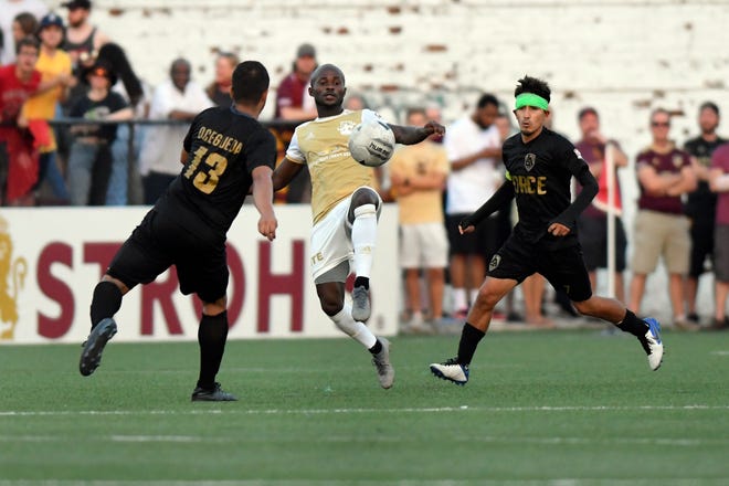 Detroit City FC midfielder Cyrus Saydee, center, fights for the ball against L.A. Force defenseman Juan Pablo Ocegueda, left, and midfielder Abraham Villon in the second half, Saturday, July 3, 2021 during the NISA Championship held at Keyworth Stadium in Hamtramck.  Detroit defeated L.A. 1-0.