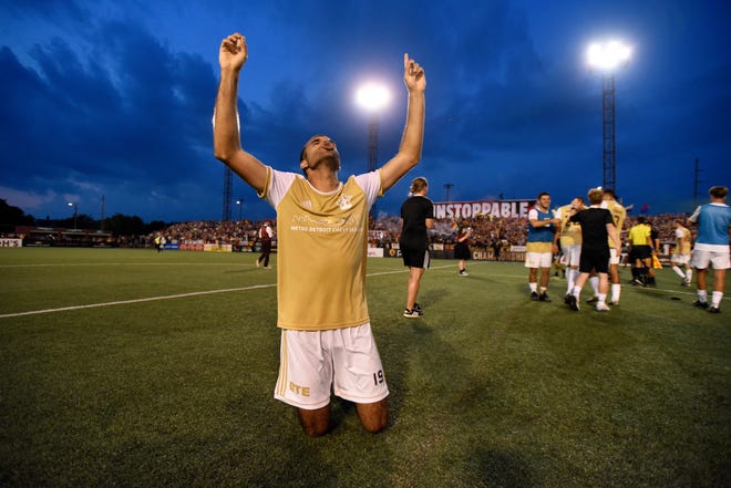 Detroit City FC forward Patricio Botello prays at midfield after his team won against the L.A. Force.