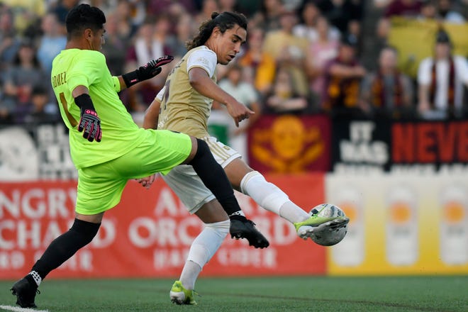 Detroit City FC midfielder Maxi Rodriguez, right, tries to get control of the ball ahead of L.A. Force goalkeeper Hugo Gomez, but Rodriguez was called for a handball during the second half, Saturday, July 3, 2021 during the NISA Championship held at Keyworth Stadium in Hamtramck.  Detroit defeated L.A. 1-0.