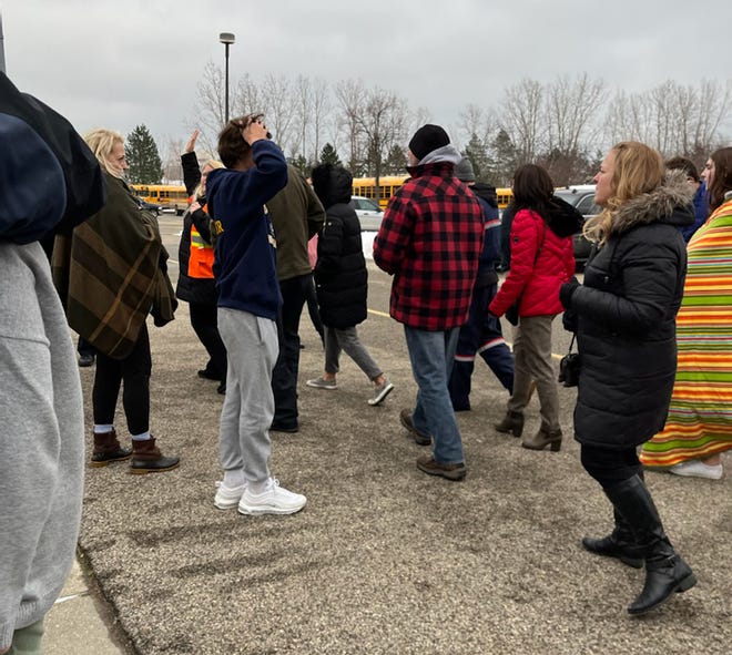 Unidentified parents look for teens at the Oxford Meijer store after the mass shooting at Oxford High School on Tuesday afternoon, Nov. 30, 2021 that killed four students and wounded seven others, including a teacher, inside the school.