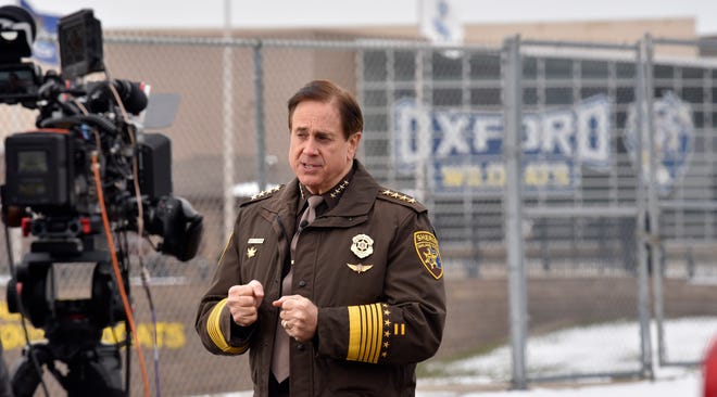 A national CBS News crew interviews Oakland County Sheriff Michael Bouchard in the Oxford High School Parking lot on Wednesday, Dec. 1, 2021, a day after a 15-year-old male student is accused of fatally shooting four students and wounding seven others, including a teacher.