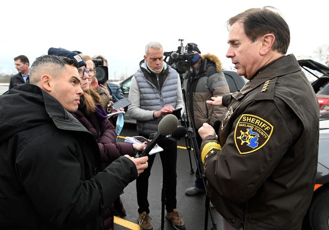 National and local media crews interview Oakland County Sheriff Michael Bouchard in the Oxford High School parking lot on Wednesday, Dec. 1, 2021.