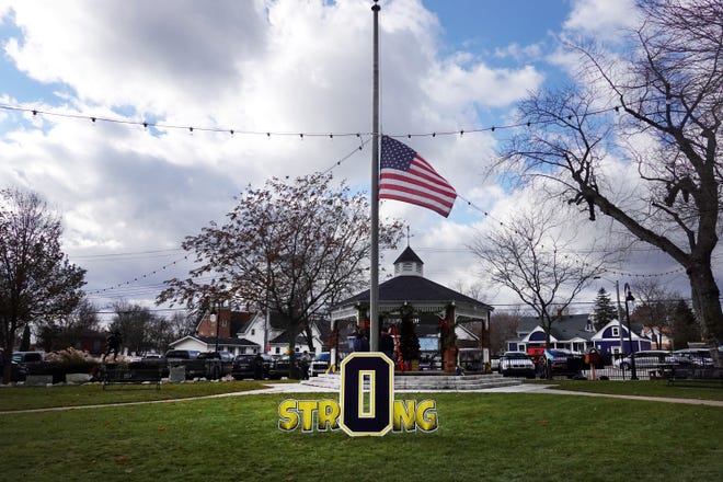 A flag flies at half mast in Centennial Park in honor of the students and staff killed and wounded in the November 30 shooting at Oxford High School on December 2, 2021 in Oxford, Michigan.  Four students were killed and seven others injured when student Ethan Crumbley allegedly opened fire with a pistol in the school.