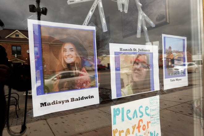 Pictures in the window of a downtown business honor students killed in the Nov. 30 shooting at Oxford High School on Dec. 2, 2021 in Oxford.  Four students were killed and seven others including a teacher injured when student Ethan Crumbley allegedly opened fire with a handgun in the school.