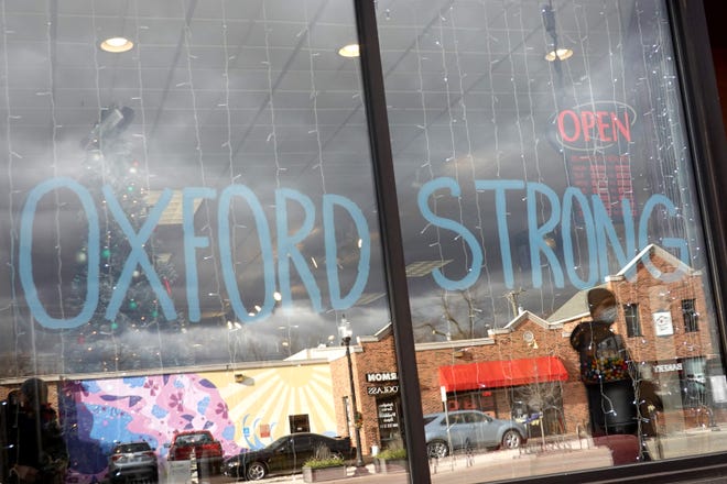 A sign in the window of a downtown business shows support for the students and staff killed and wounded in the November 30 shooting at Oxford High School on December 2, 2021 in Oxford, Michigan.  Four students were killed and seven others injured when student Ethan Crumbley allegedly opened fire with a pistol in the school.
