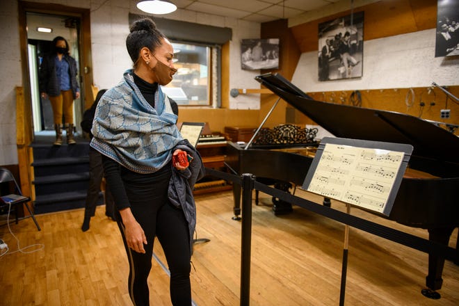 Dance Theatre of Harlem dancer Alexandra Hutchinson looks at sheet music for the song "My Girl" as she tours Studio A during a visit to the Motown Museum, Tuesday, Dec. 14, 2021. The group will be performing at Michigan Opera Theatre in January.