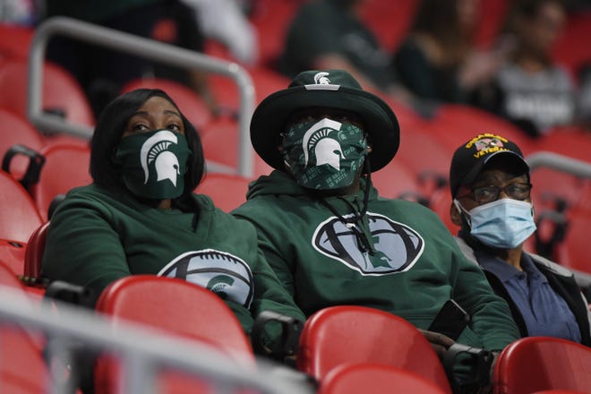 Masked MSU fans in the stands at Mercedes-Benz Stadium Atlanta.