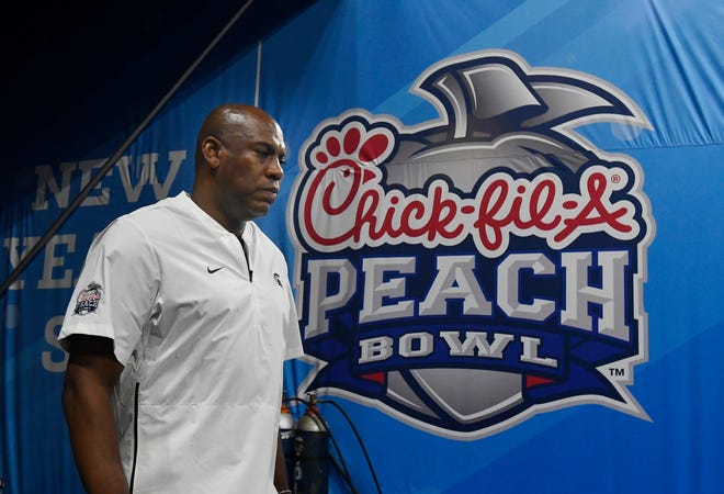 MSU head coach Mel Tucker makes his way onto the field for the Peach Bowl in Atlanta.