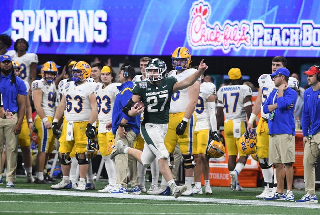 Michigan State’s Cal Haladay is all smiles after intercepting a pass from Pitt quarterback Davis Beville and taking it in for a touchdown with under a minute left in the game.