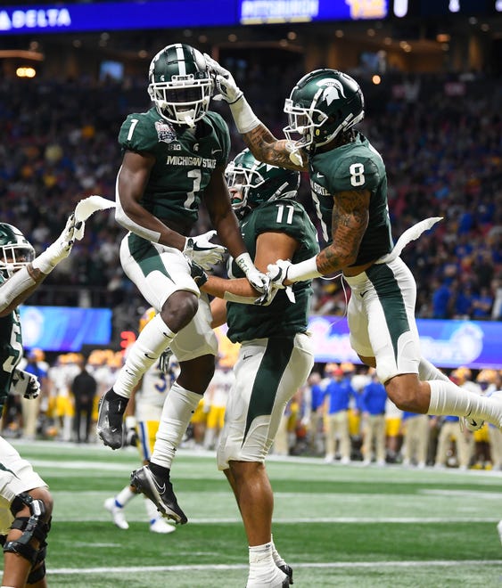 Michigan State's Jayden Reed (1), Connor Heyward and Jalen Nailor (8) celebrate Reed's long touchdown reception in the first quarter.
