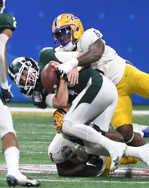 Pitt's John Morgan III and Calijah Kancey hit Michigan State quarterback Payton Thorne, forcing the turnover that Chase Pine recovers and takes into the end zone for a touchdown in the third quarter.