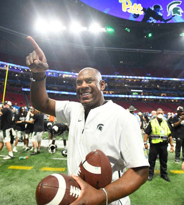 MSU head coach Mel Tucker points up to the Spartan fans still in Mercedes Benz Stadium after beating Pitt in the Peach Bowl.