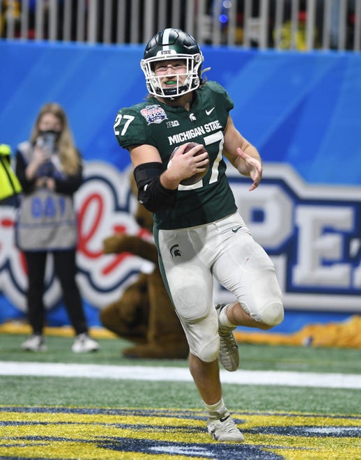 Michigan State's Cal Haladay is all smiles after taking an interception of Pitt quarterback Davis Beville's pass and taking it all the way home for a touchdown with under a minute left on the clock in the fourth quarter.