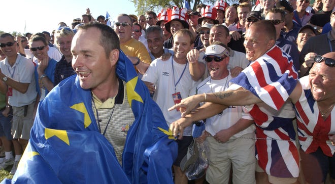 Billy Foster (Darren Clarke's caddie) is surrounded by European fans on the 18th hole. The European team celebrates around the 18th green after beating the Americans, 18.5 to 9.5 in the final round of The 35th Ryder Cup Matches at The Oakland Hills Country Club, Sunday afternoon, September 19, 2004.