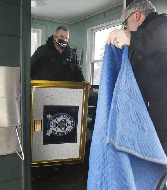 CRDN, fire damage restoration, President Marty Cook and Vice President Paul Cousineau remove pieces of art and memorabilia that were rescued from the fire at the main building at Oakland Hills Country Club and placed in the main guard shed.