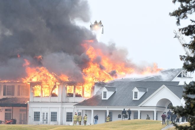 Flames shoot from the main building at the Oakland Hills Country Club in Bloomfield Township on Thursday, Feb. 17, 2022.