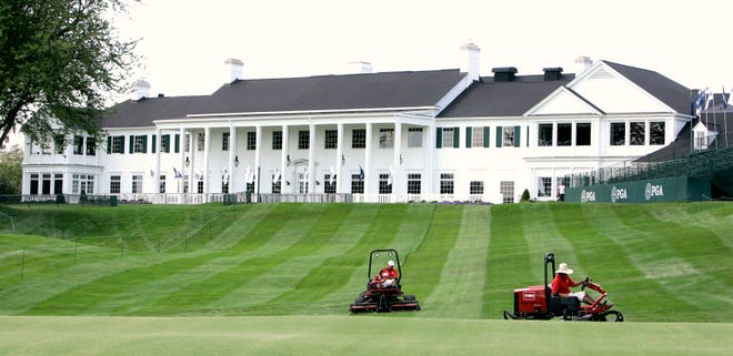 Grounds keepers mow the rough in front of the clubhouse while preparing for the 90th PGA Championship at Oakland Hills Country Club on August 1, 2008.
