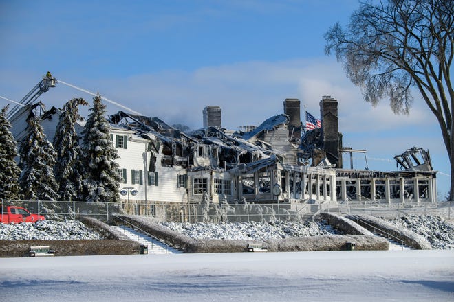 Firefighters continue to pour water on the Oakland Hills Country Club Friday morning, Feb. 18, 2022, one day after a devastating fire.