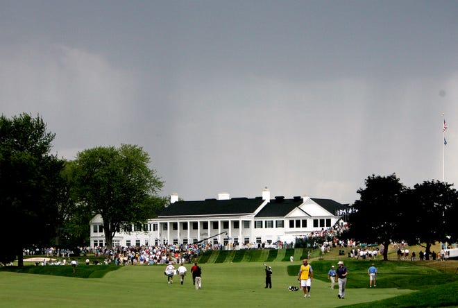 Angel Cabrera and Brandt Snedeker walk off the first hole after officials sound the severe weather horn and play is suspended during the third round of the 90th PGA Championship at the Oakland Hills Country Club in 2008.