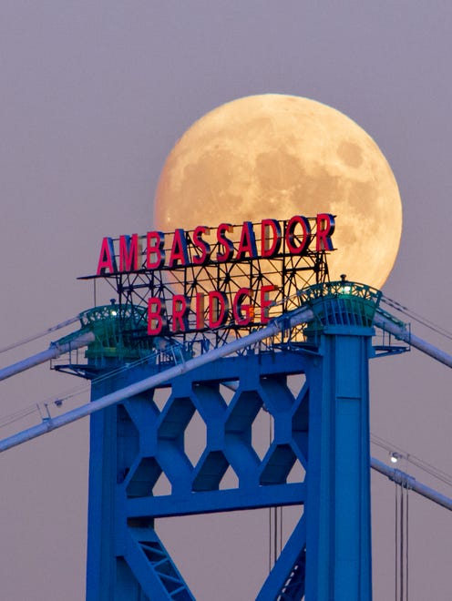FINALIST: People and Places - Anthony Kaled of Detroit picked the perfect angle to capture this masterful shot of the full moon and Ambassador Bridge in Detroit.